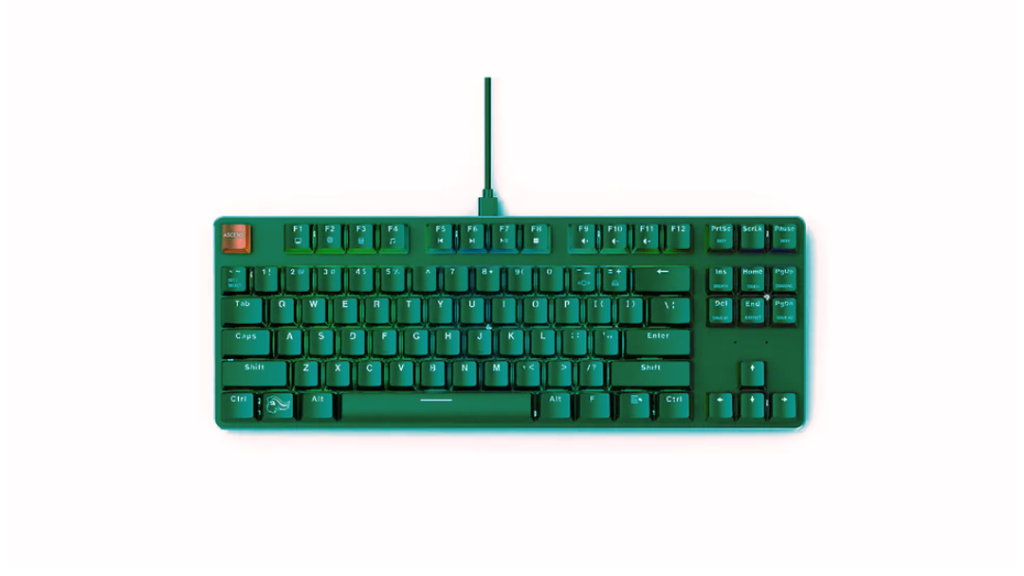 A portable green keyboard with a cord, designed for programming purposes.