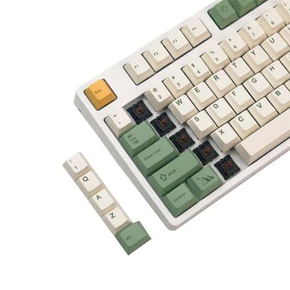 A keyboard with a white and green color scheme, featuring a prominent green key.


