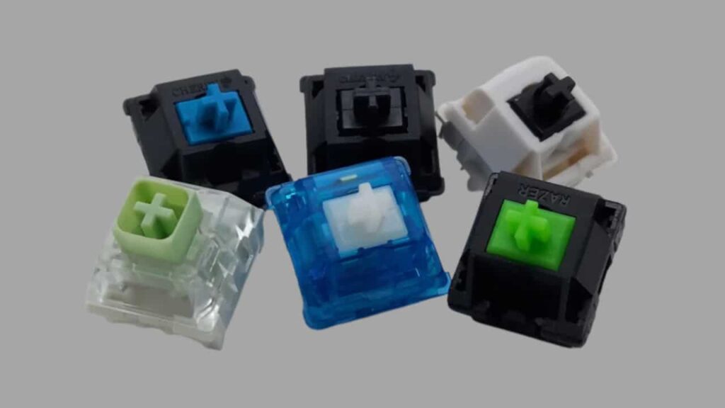 Six different thock keyboard switches: Gateron Milky Yellow, NovelKeys Cream, Alpacas, Gazzew Boba U4, and Durock POM Linears. The switches are arranged in a row, and each switch is labeled with its name.

