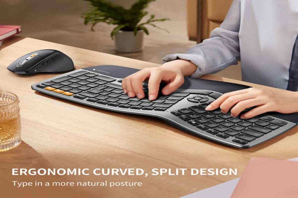 A man typing on an ergonomic keyboard and using a mouse.


