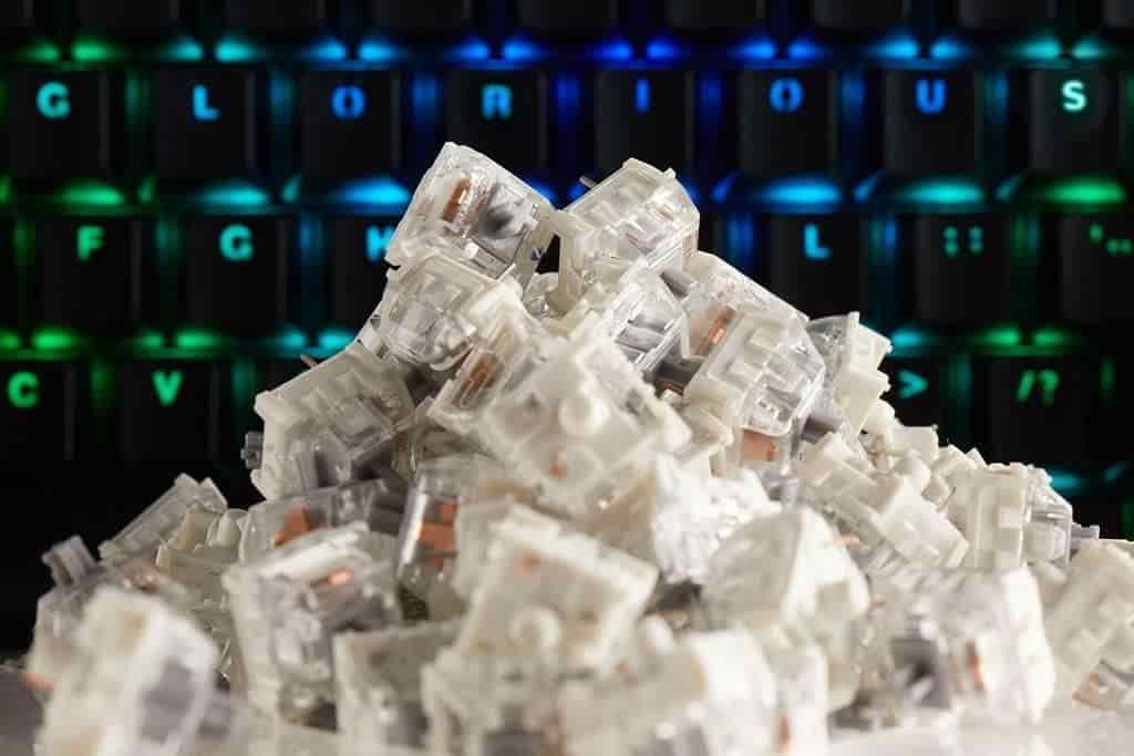 A pile of white plastic pieces on a keyboard, representing Kailh Switch Keyboards.


